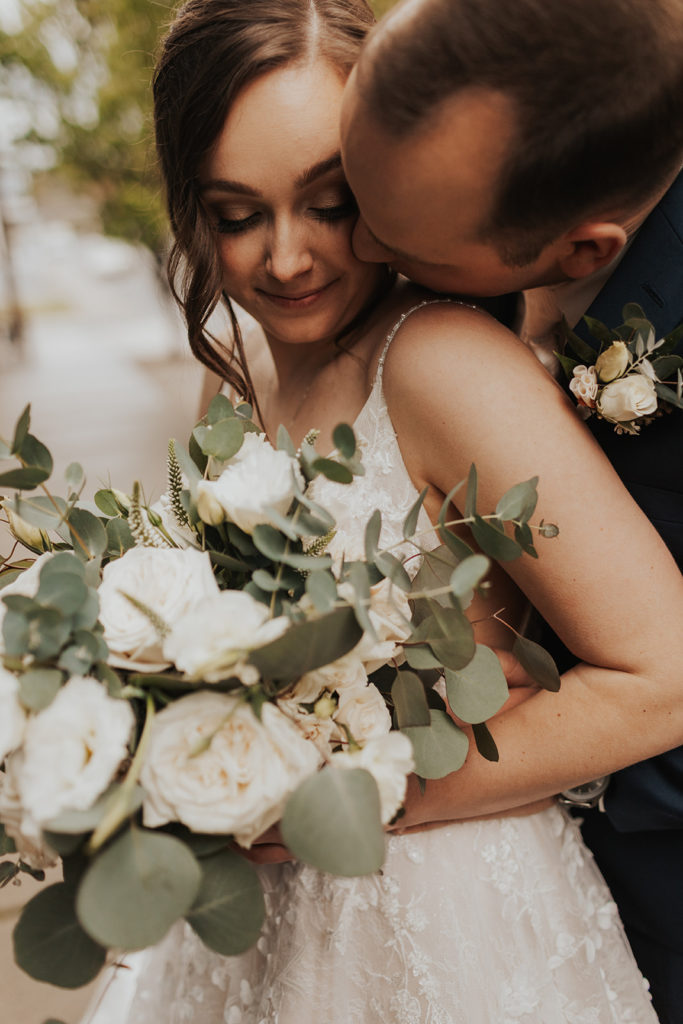 bride and groom with floral bouquet