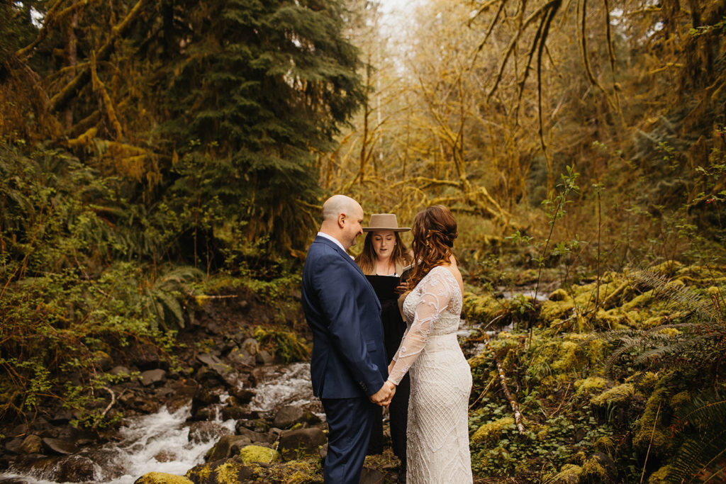 rain forest elopement bride and groom with officiant in background