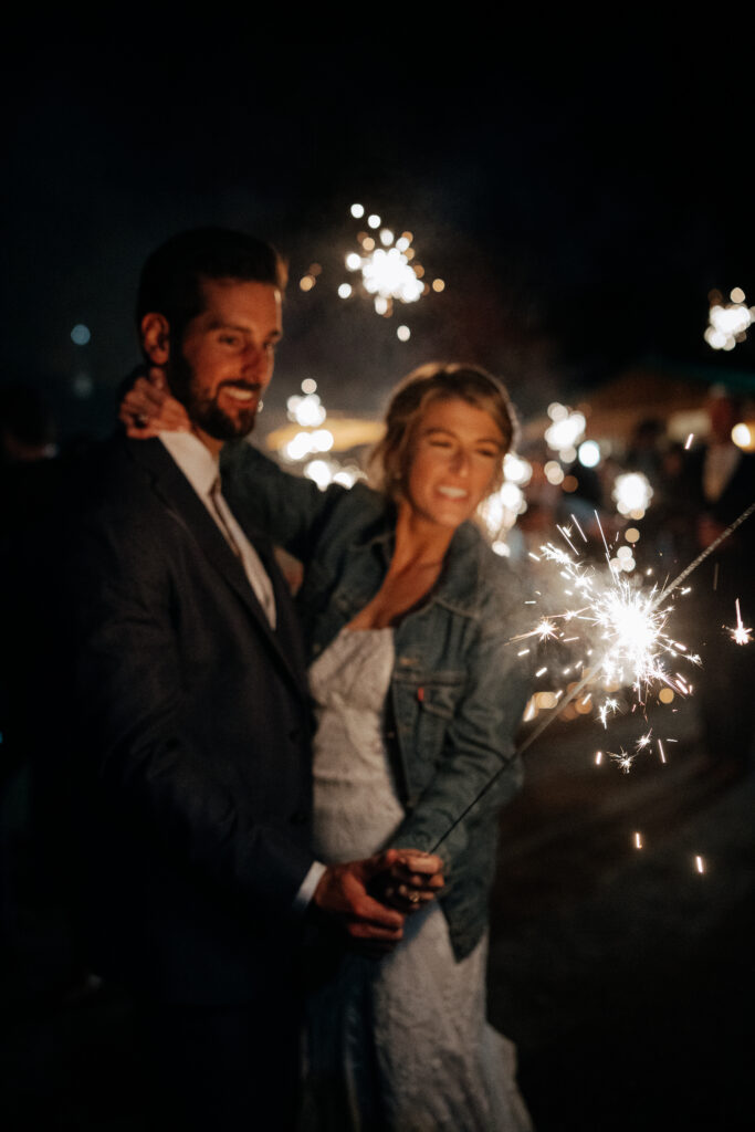 wedding couple celebrating with fireworks wedding in idaho
