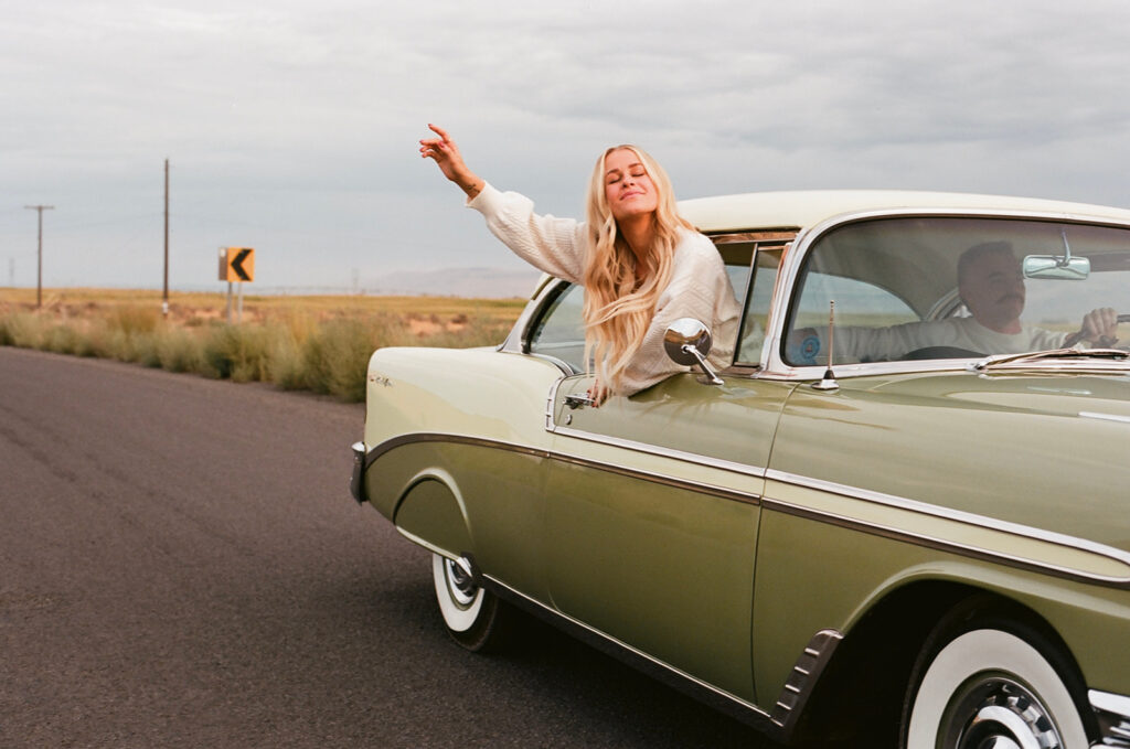 Girl out the window of a classic car 35mm film at a Royal City, WA engagement session.