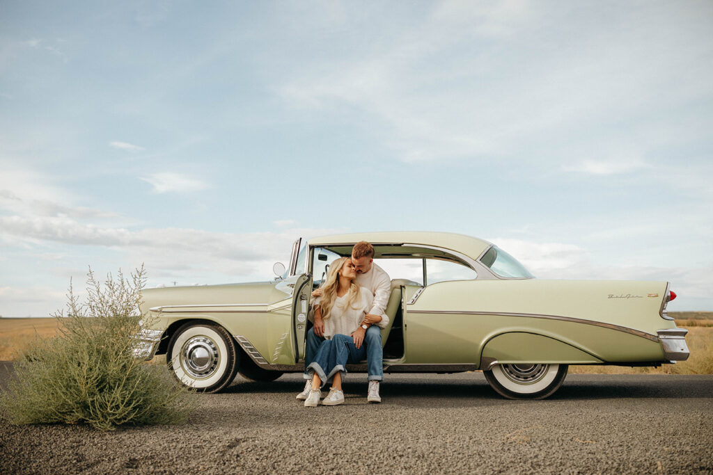 Retro vibes during an engagement session with couple in driver seat door in Royal City, WA