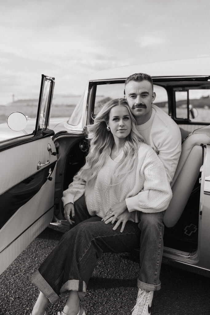 Couple with windblown hair during a Royal city engagement session portrait.