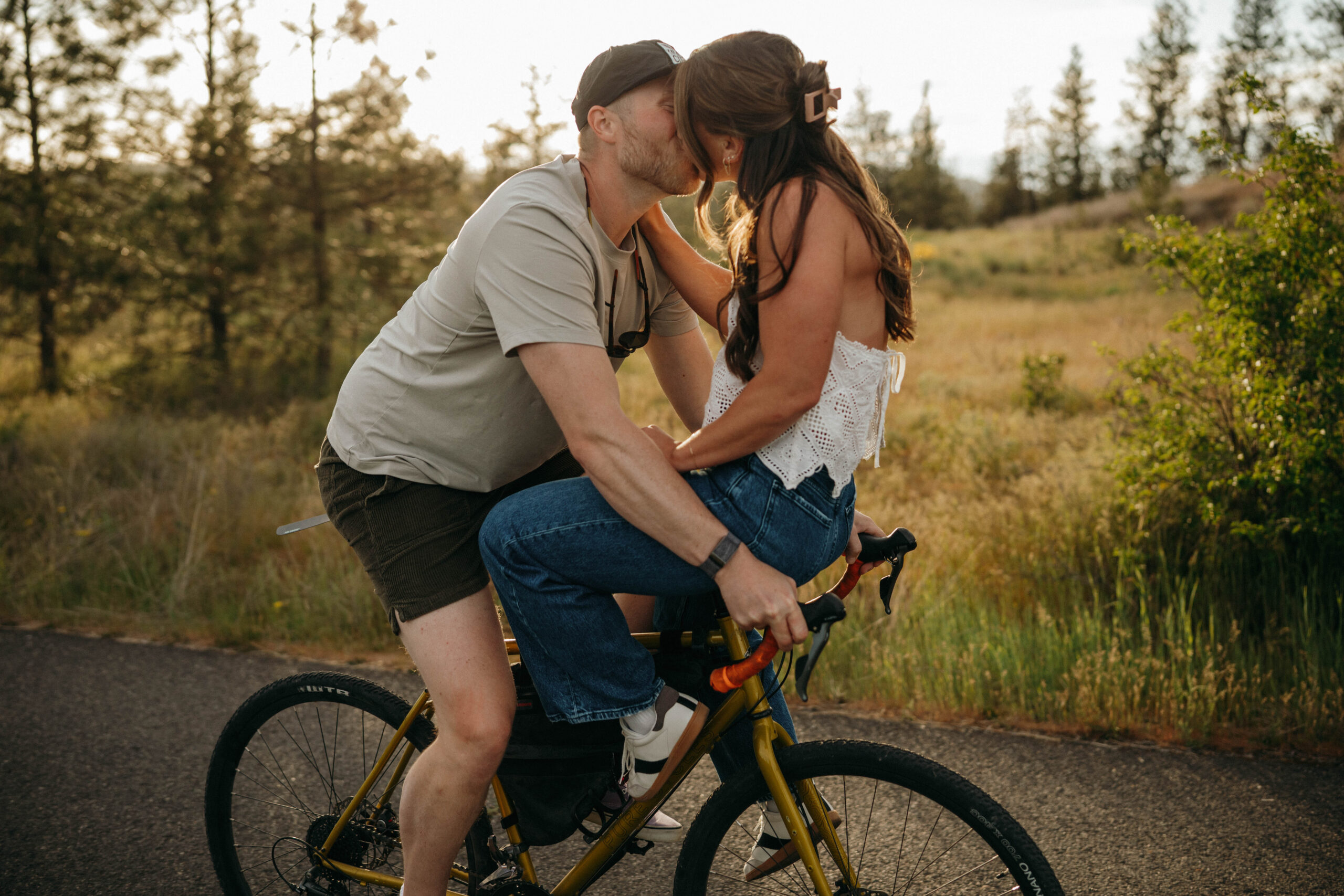 sunset photo of couple on a bike for engagement photos