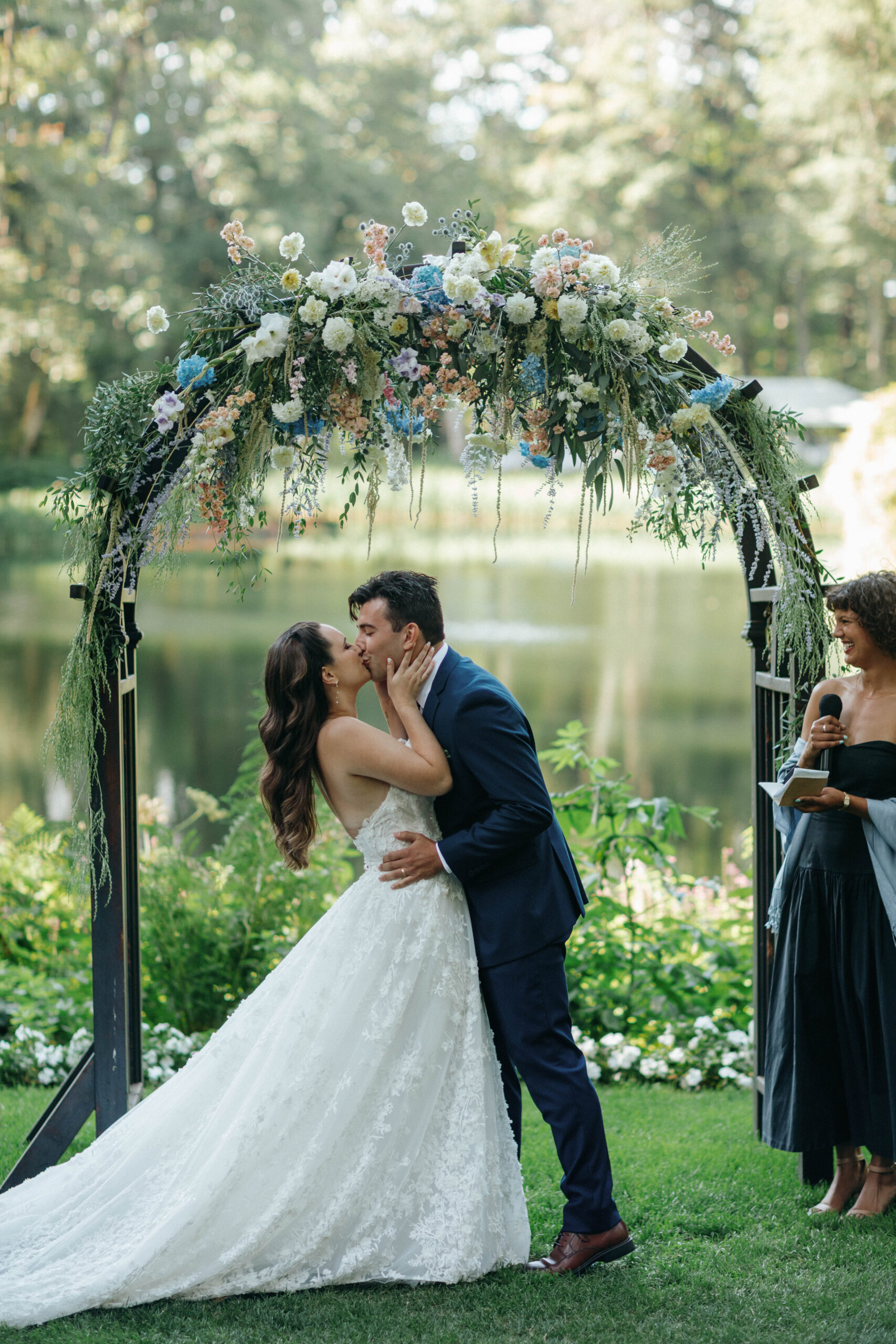 a wedding couple sharing their first kiss at bridal veil lakes wedding venue in oregon